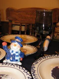 Snowman figurine and blue stem