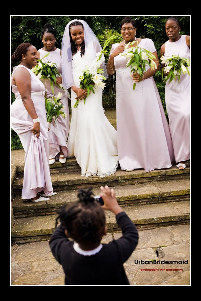 Little Girl shooting bridal party with camera phone