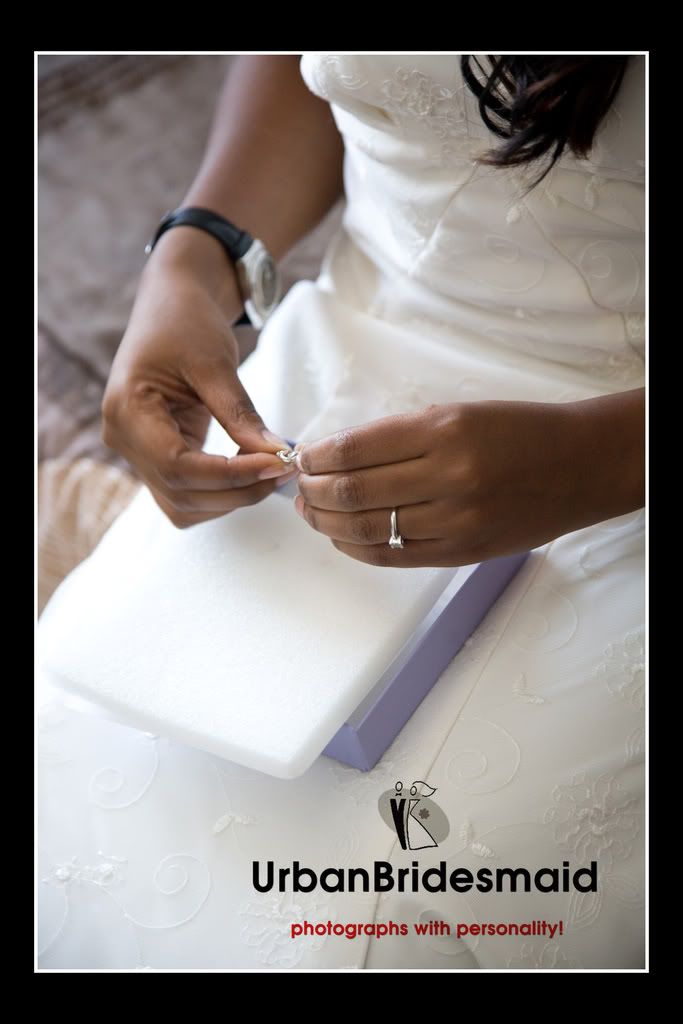 Bride putting on jewellery